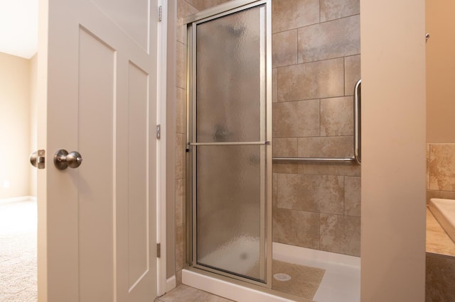 bathroom featuring a shower with door