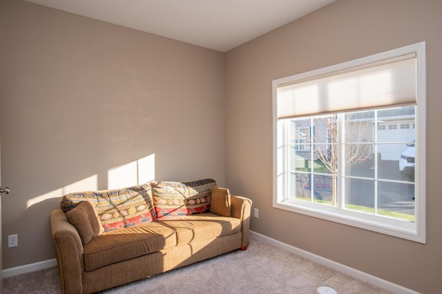 carpeted living room with baseboards