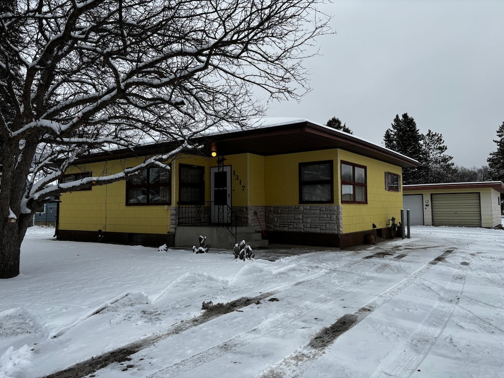 view of front facade with an outbuilding and a garage