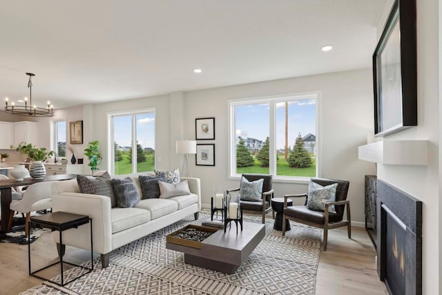 living room with light hardwood / wood-style floors and a chandelier