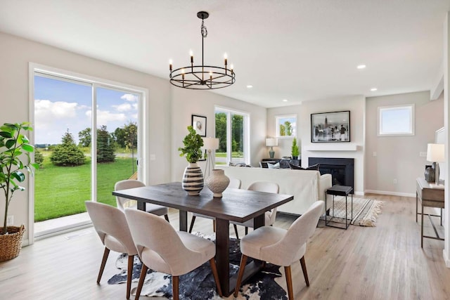 dining room featuring light hardwood / wood-style flooring and an inviting chandelier