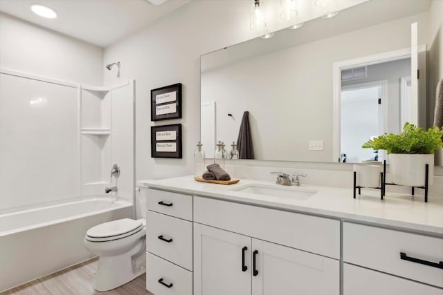 full bathroom featuring toilet, hardwood / wood-style floors, vanity, and tub / shower combination