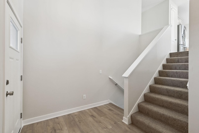 stairs featuring hardwood / wood-style floors