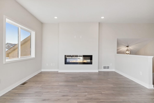 unfurnished living room with light hardwood / wood-style floors