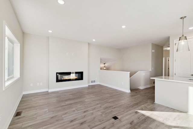 unfurnished living room featuring light hardwood / wood-style flooring