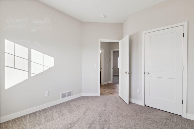 unfurnished bedroom with light carpet