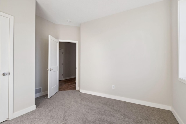 unfurnished bedroom featuring light carpet