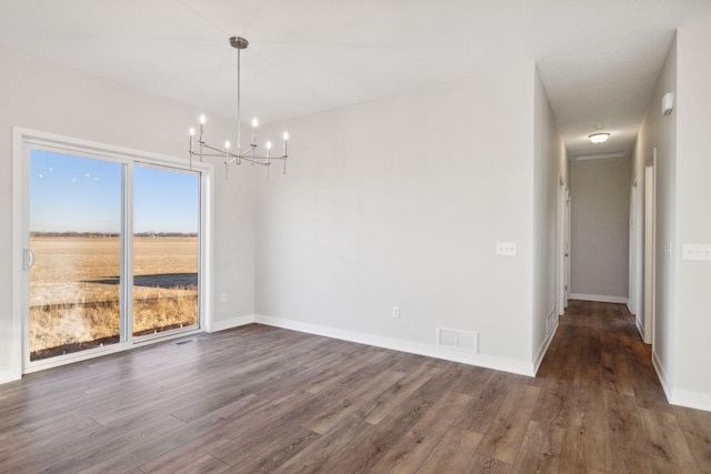 unfurnished dining area with dark hardwood / wood-style floors and a chandelier