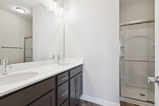 bathroom with vanity and a shower with shower door