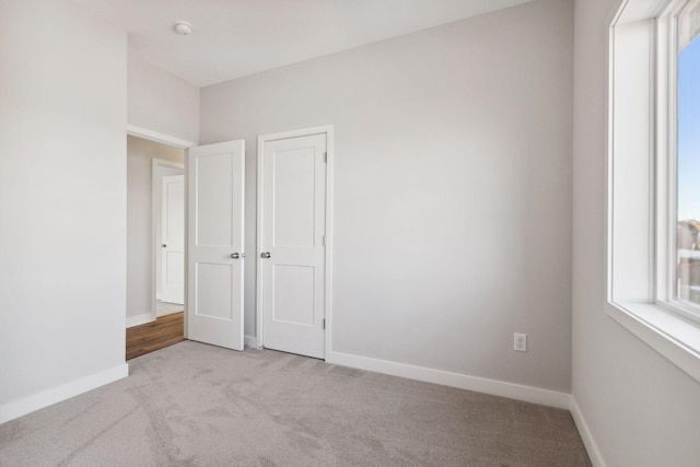 unfurnished bedroom with light colored carpet