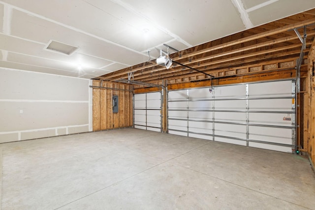 garage featuring a garage door opener and electric panel