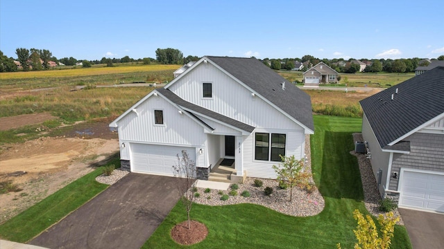 modern farmhouse style home with a garage and a front lawn