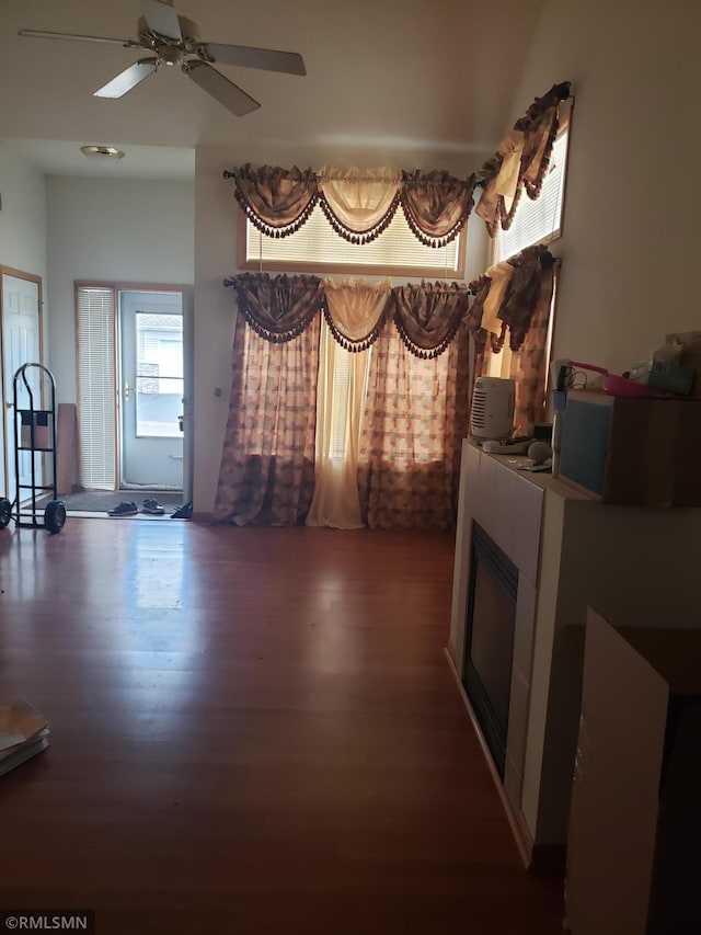 living room featuring dark hardwood / wood-style floors and ceiling fan