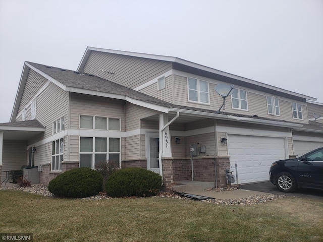 view of front of house featuring a front yard and a garage