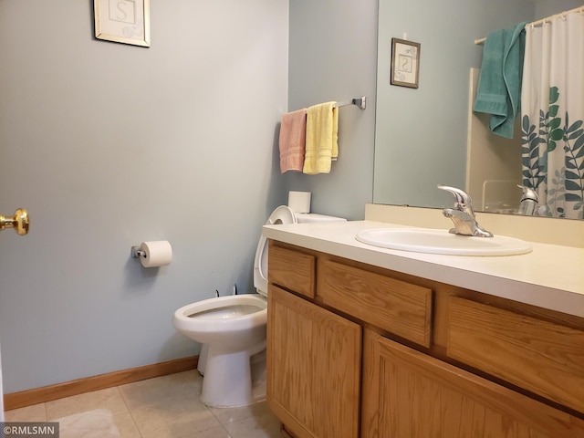 bathroom featuring tile patterned flooring, vanity, and toilet