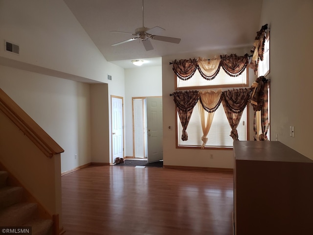 spare room featuring hardwood / wood-style flooring, high vaulted ceiling, and ceiling fan