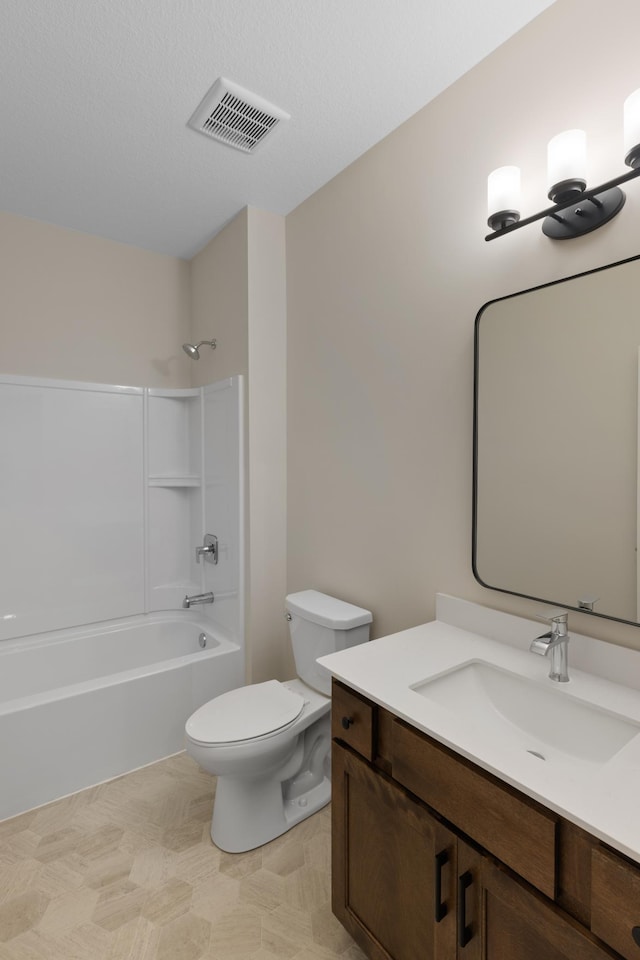 full bathroom with toilet, a textured ceiling, vanity, and bathing tub / shower combination