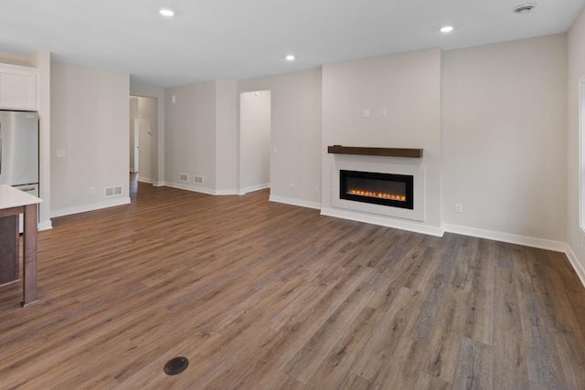 unfurnished living room featuring dark wood-type flooring