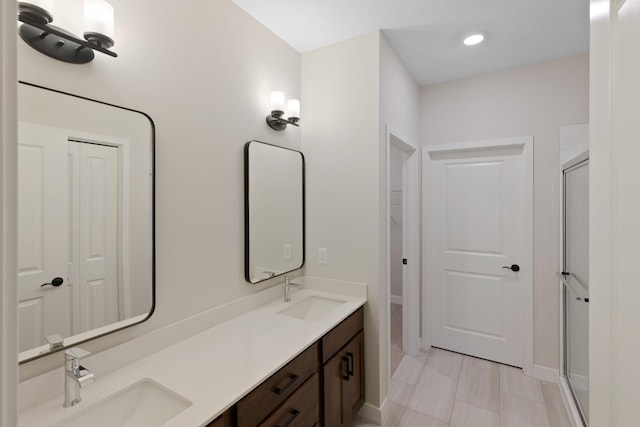 bathroom with vanity and a shower with shower door