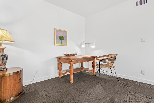 office area featuring carpet flooring, visible vents, and baseboards