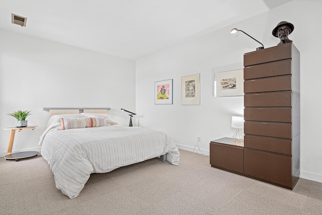 carpeted bedroom featuring visible vents and baseboards