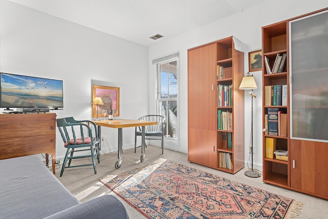 home office with carpet, visible vents, and baseboards