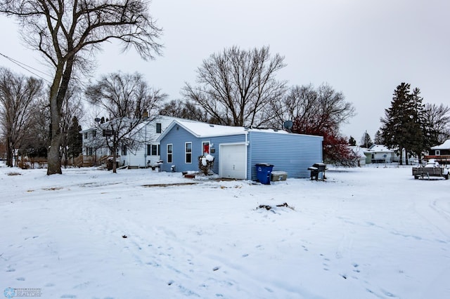 view of snow covered back of property