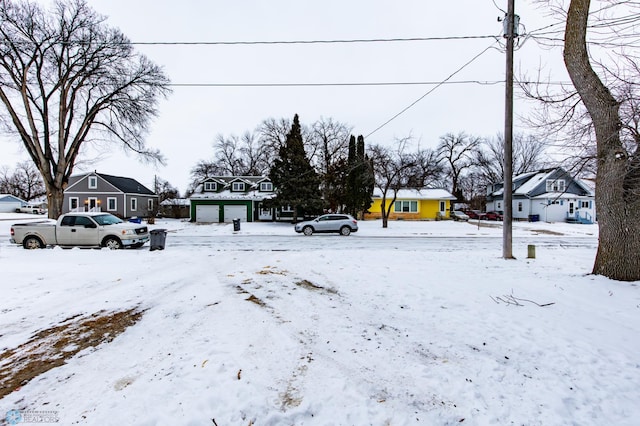 yard covered in snow with a garage