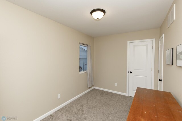 empty room featuring light carpet