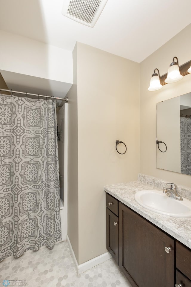 bathroom featuring vanity and shower / bath combination with curtain