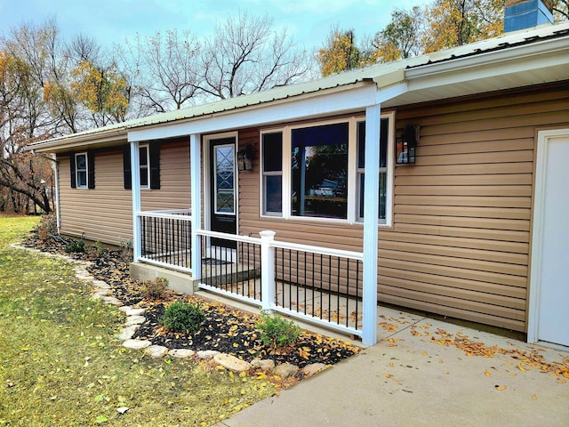 view of side of property with covered porch