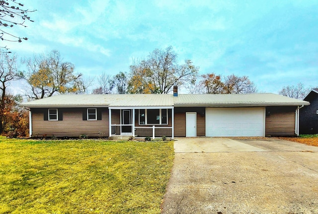 ranch-style house featuring a front yard and a garage