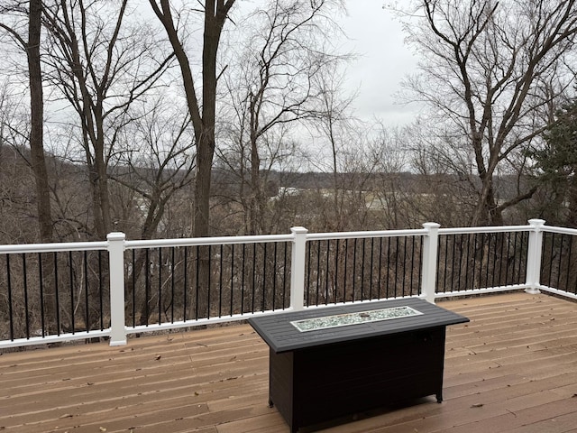 wooden terrace with an outdoor fire pit