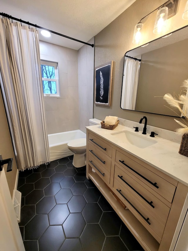 full bathroom featuring shower / bath combo, tile patterned floors, a textured ceiling, toilet, and vanity