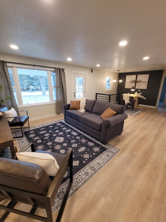 living room featuring a textured ceiling and light hardwood / wood-style floors