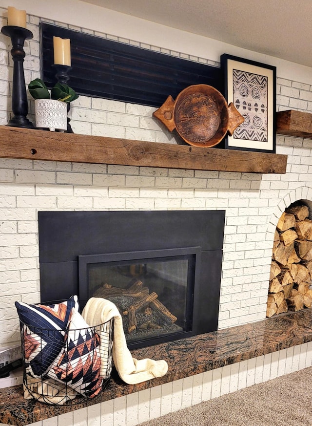 room details with carpet and a brick fireplace