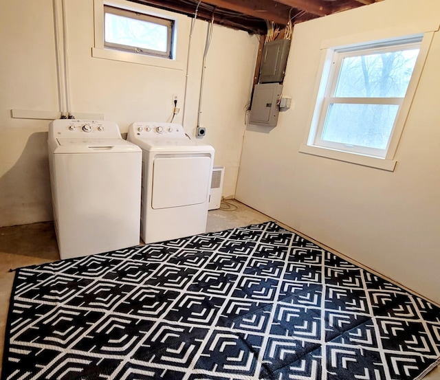 laundry room featuring washer and clothes dryer, a healthy amount of sunlight, and electric panel