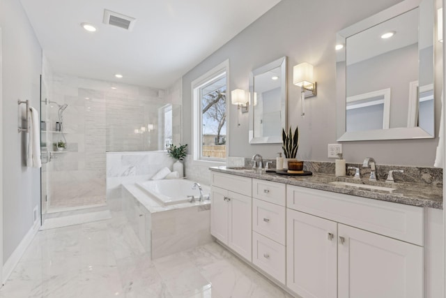 full bathroom with marble finish floor, a garden tub, a sink, and visible vents