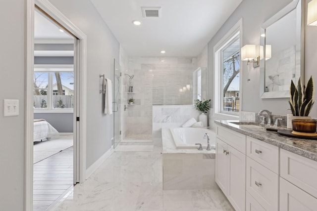 ensuite bathroom featuring a stall shower, visible vents, connected bathroom, a garden tub, and vanity