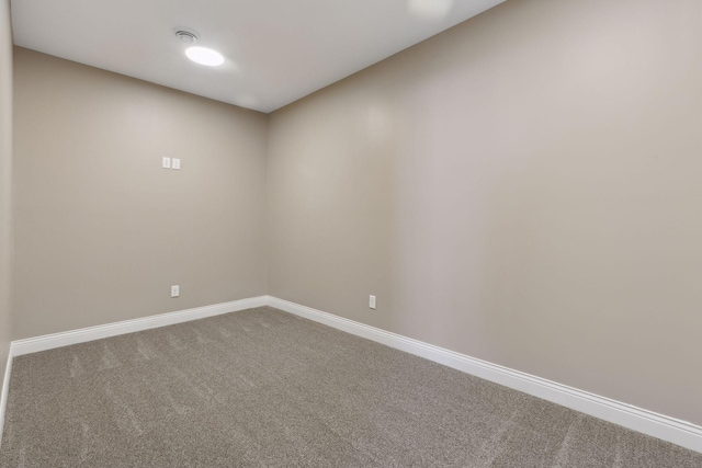 carpeted empty room with baseboards