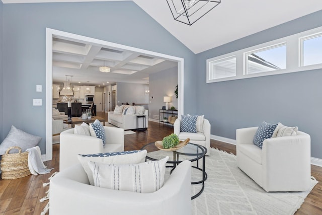 living area with coffered ceiling and wood finished floors