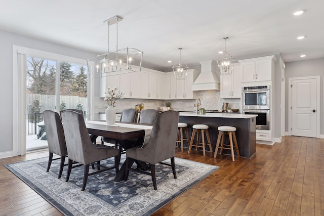 dining space with dark wood-type flooring, recessed lighting, and baseboards