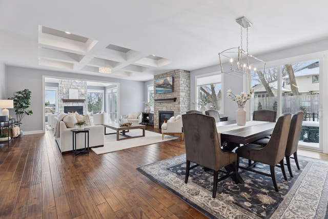 dining space featuring a fireplace, coffered ceiling, baseboards, beam ceiling, and dark wood-style floors