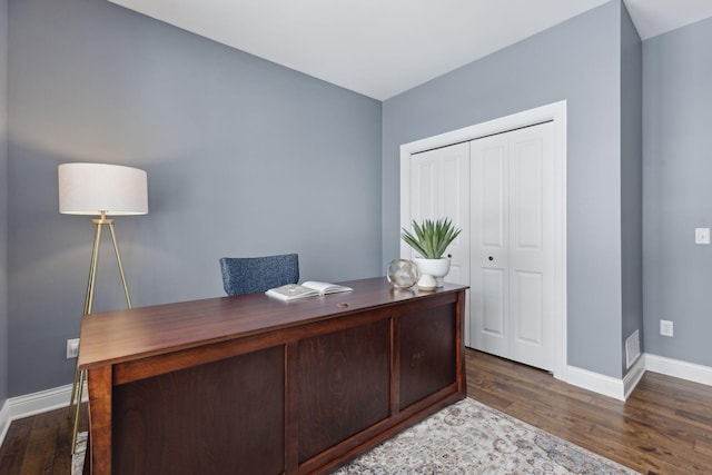 office space featuring baseboards and wood finished floors