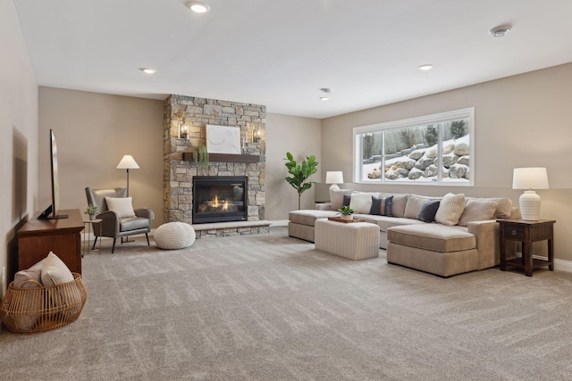 living area with recessed lighting, light carpet, a stone fireplace, and baseboards