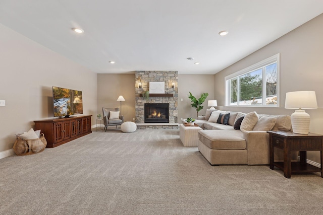 living area with baseboards, a stone fireplace, recessed lighting, and light colored carpet