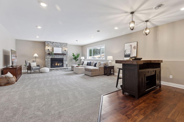 living room featuring recessed lighting, a fireplace, and baseboards