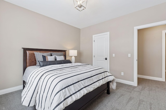 carpeted bedroom featuring baseboards