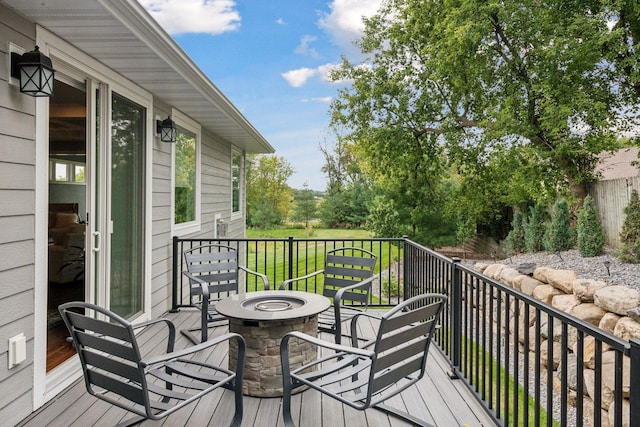 wooden deck with a fire pit