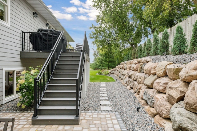 view of yard with stairway, a patio area, and fence